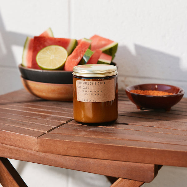 P.F. Candle Co. Watermelon & Chili Standard Candle - Lifestyle - Fresh cut fruit, hand-squeezed citrus, cool grass on a hot day. Tart yet earthy. Watermelon, summer grass, dried chili, and lime. 