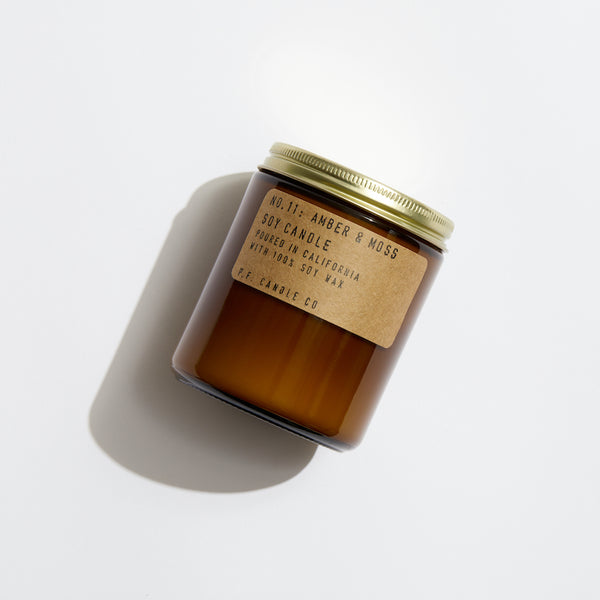 P.F. Candle Co. Amber & Moss Standard Candle - Product - Hand-poured into apothecary inspired amber jars with our signature kraft label and a brass lid.