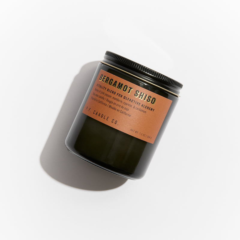P.F. Candle Co. Los Angeles - Bergamot Shiso Alchemy 7.2 oz Standard Scented Soy Wax Candle - Product - Alchemy Candles feature smoke-colored glass vessels, black metal lids, and gold-leafed labels inspired by vintage window lettering.