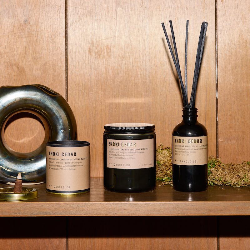 P.F. Candle Co. Enoki Cedar - Scent Family - Alchemy is a collection of candles, incense cones, and reed diffusers featuring science-backed blends meant to mimic the healing qualities of nature and boost your mood.