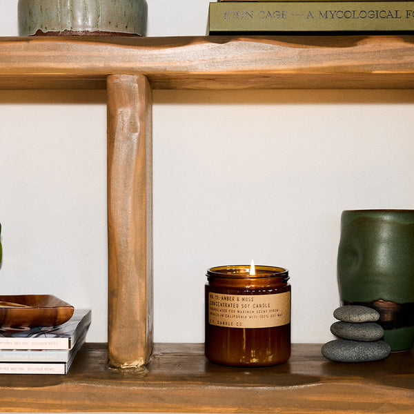 P.F. Candle Co. Amber & Moss Large Concentrated Candle - Lifestyle - A weekend in the mountains, sun gleaming through the canopy. Sage, moss, and lavender.