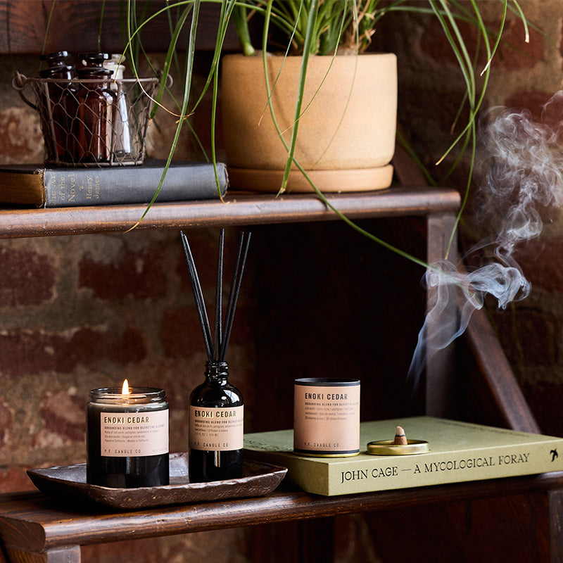 P.F. Candle Co. Enoki Cedar - Scent Family - Alchemy is a collection of candles, incense cones, and reed diffusers featuring science-backed blends meant to mimic the healing qualities of nature and boost your mood.