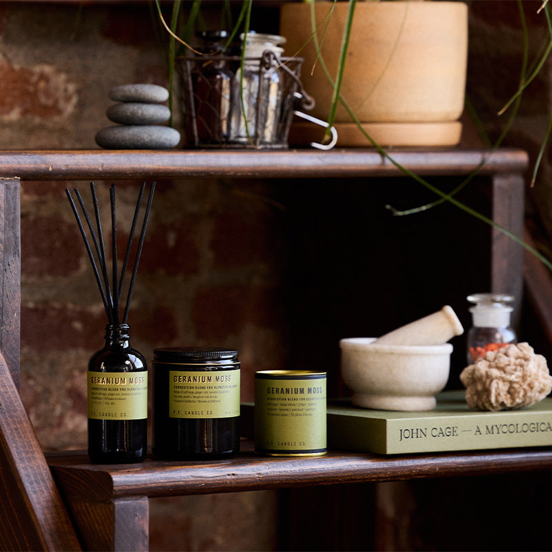 P.F. Candle Co. Geranium Moss - Scent Family - Alchemy is a collection of candles, incense cones, and reed diffusers featuring science-backed blends meant to mimic the healing qualities of nature and boost your mood.