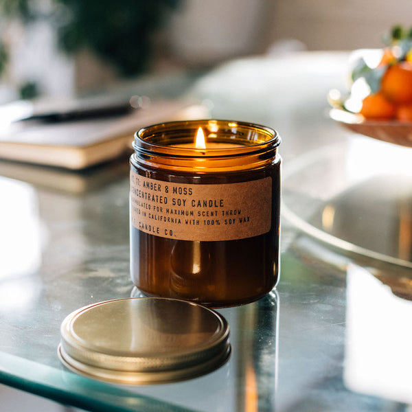 P.F. Candle Co. Amber & Moss Large Concentrated Candle - Lifestyle - A weekend in the mountains, sun gleaming through the canopy. Sage, moss, and lavender.