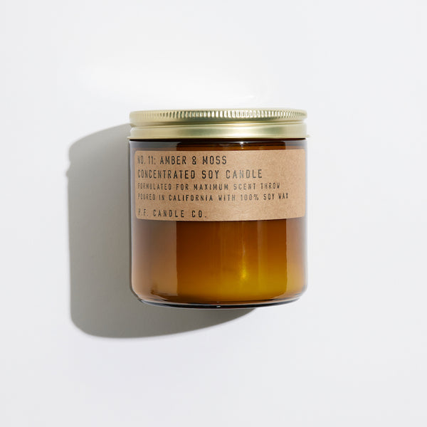 P.F. Candle Co. Amber & Moss Large Concentrated Candle - Product - Hand-poured into apothecary inspired amber jars with our signature kraft label and a brass lid.