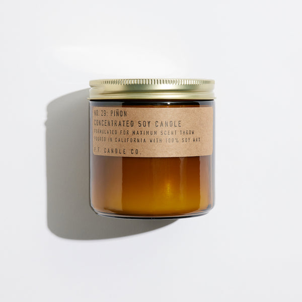 P.F. Candle Co. Piñon Large Concentrated Candle - Product - Hand-poured into apothecary inspired amber jars with our signature kraft label and a brass lid.