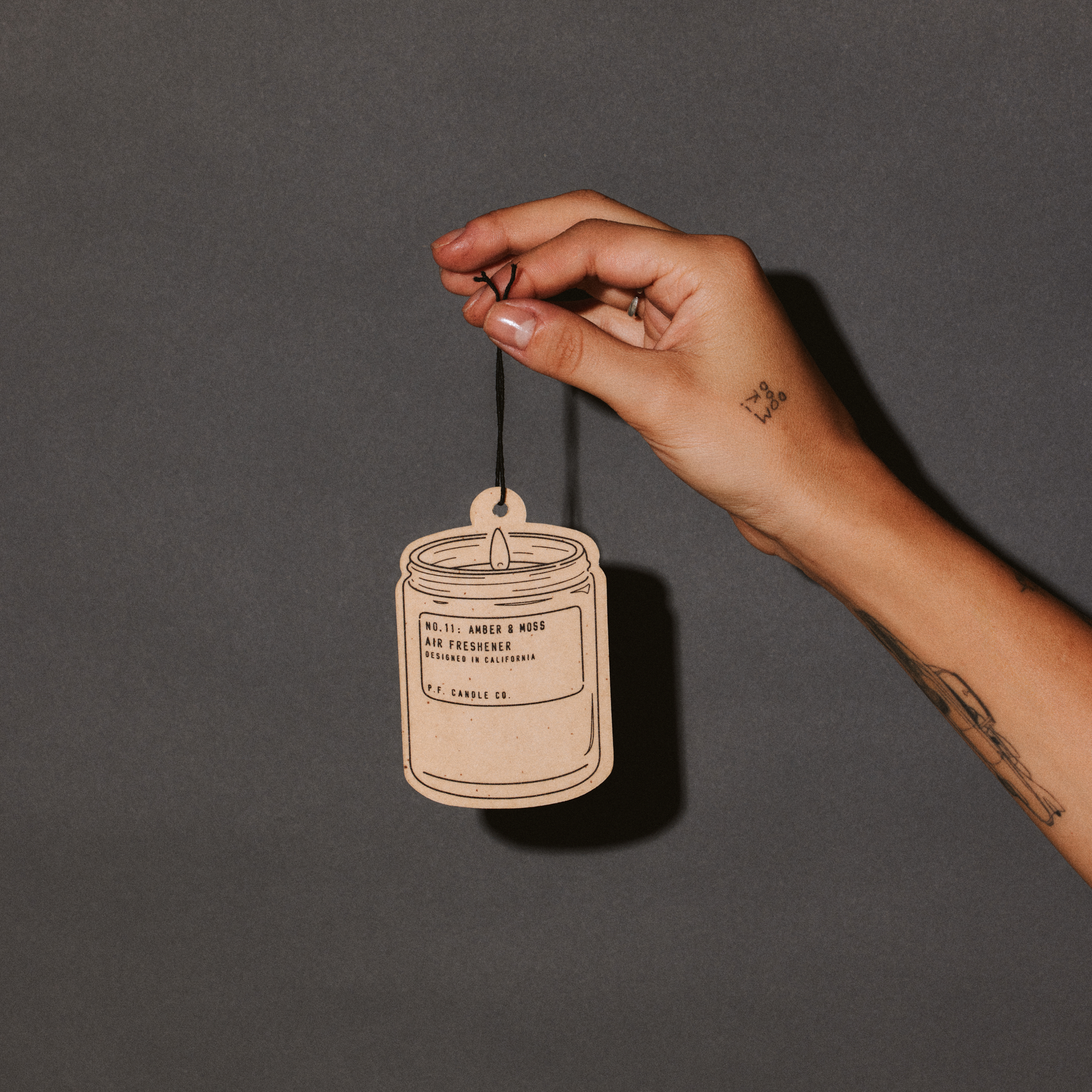 amber & moss air freshener with hand