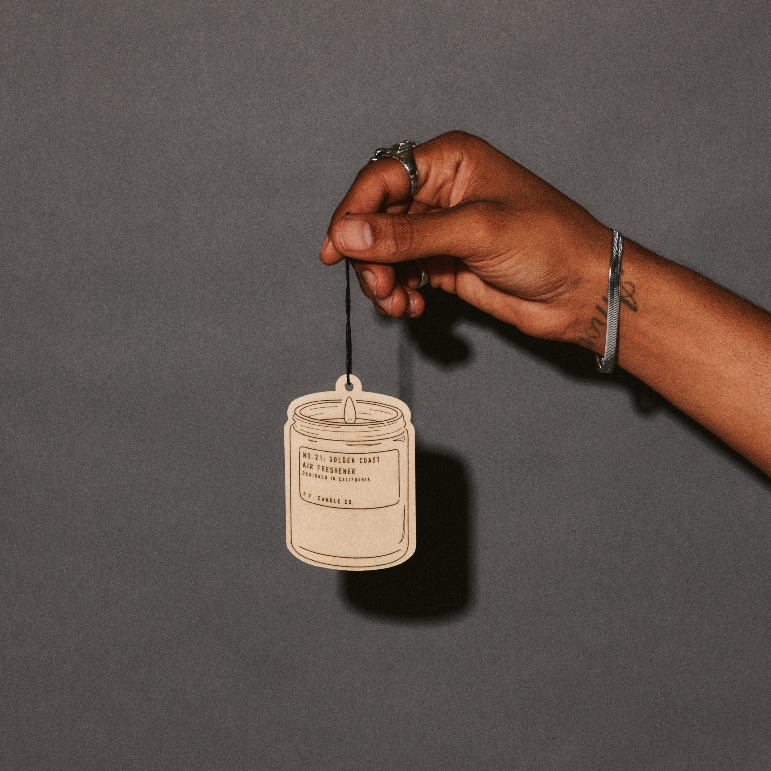 golden coast air freshener with hand