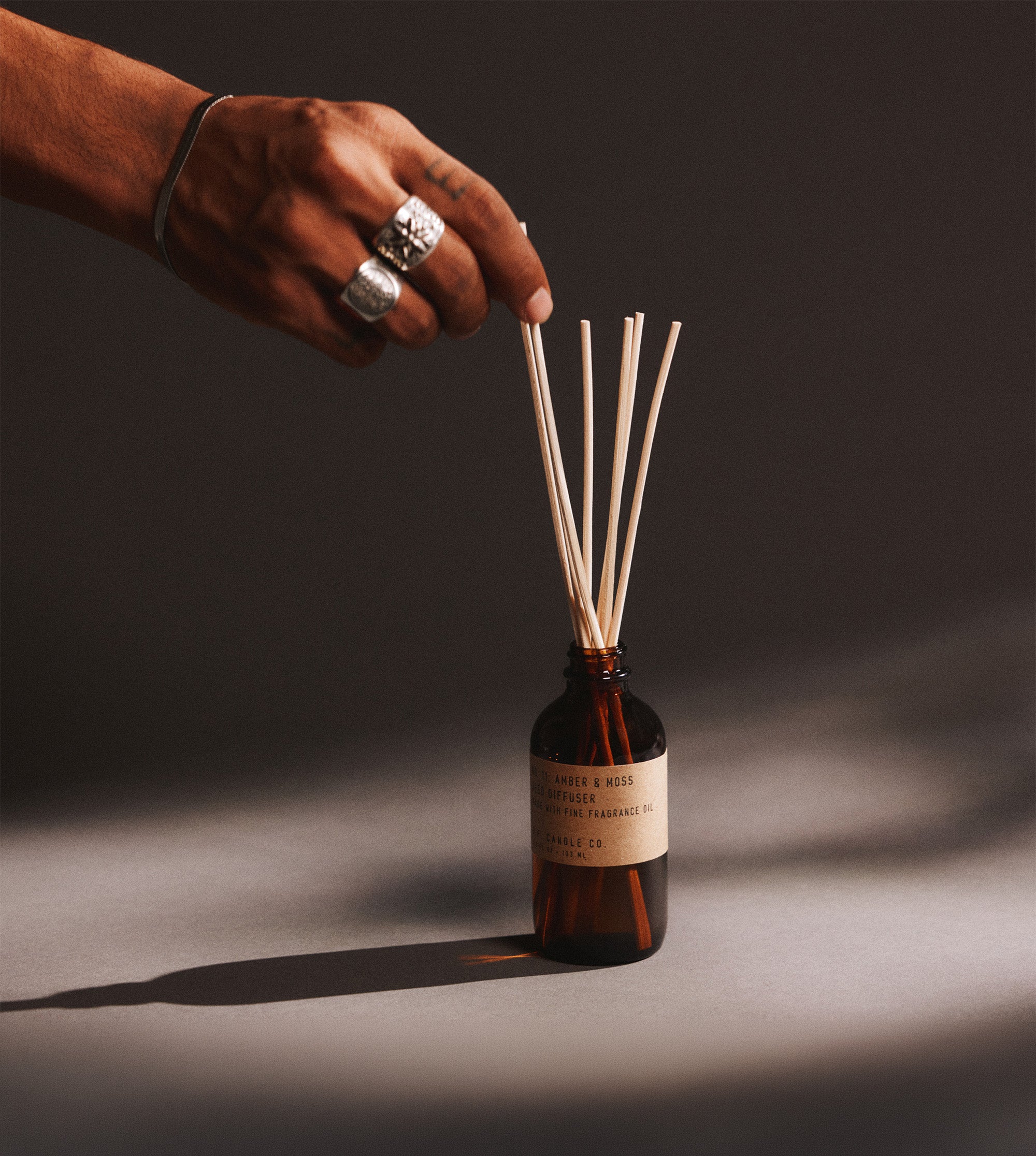 flame-free banner featuring amber & moss reed diffuser 