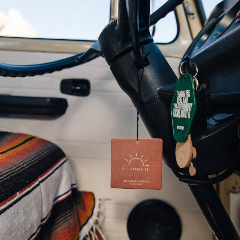 P.F. Candle Co. Los Angeles - Amber & Moss Classic Car Fragrance - Lifestyle 2 - Inspired by travel nostalgia, our love of road trips, and the power of scent to make anywhere – even the car – feel like home.