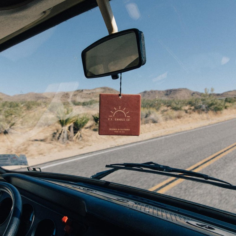 P.F. Candle Co. Los Angeles - Teakwood & Tobacco Classic Car Fragrance - Lifestyle 2 - Inspired by travel nostalgia, our love of road trips, and the power of scent to make anywhere – even the car – feel like home.