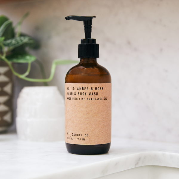 P.F. Candle Co. Amber & Moss Hand & Body Wash - Lifestyle - Scent notes of sage, moss, and lavender. Inspired by a weekend in the mountains, sun gleaming through the canopy.