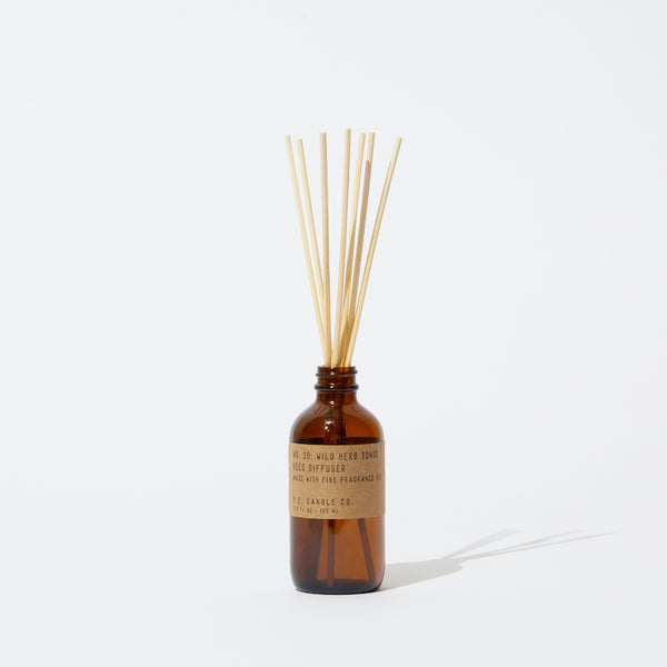 P.F. Candle Co. Wild Herb Tonic Reed Diffuser - Product - Apothecary-inspired amber glass bottles with our signature kraft label and rattan reeds. Low-maintenance scent throw, all day long - no match necessary.