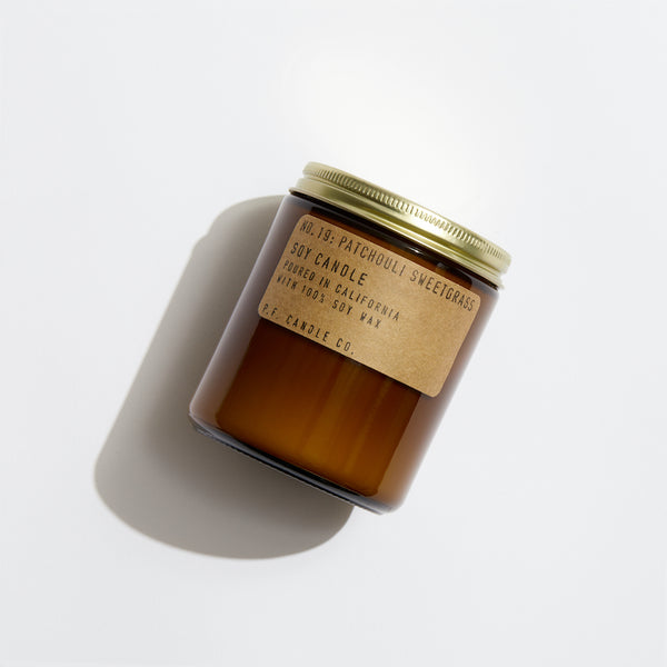 P.F. Candle Co. Patchouli Sweetgrass Standard Candle - Product - Hand-poured into apothecary inspired amber jars with our signature kraft label and a brass lid.