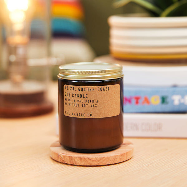 P.F. Candle Co. Golden Coast Standard Candle - Lifestyle - Big Sur magic, wild sage baking in the sun, the rumble of waves and rocks. Eucalyptus, sea salt, redwood, and palo santo.