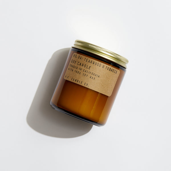 P.F. Candle Co. Teakwood & Tobacco Standard Candle - Product - Hand-poured into apothecary inspired amber jars with our signature kraft label and a brass lid.