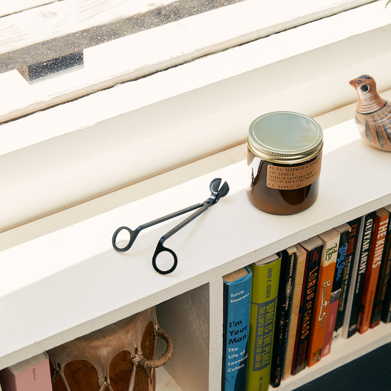 P.F. Candle Co. Wick Trimmer - Place the trimmer's long handle against the inside of the jar's rim for guidance and bring the curved scissor blades to the wick, about 1/4" from the base and parallel with the wax.